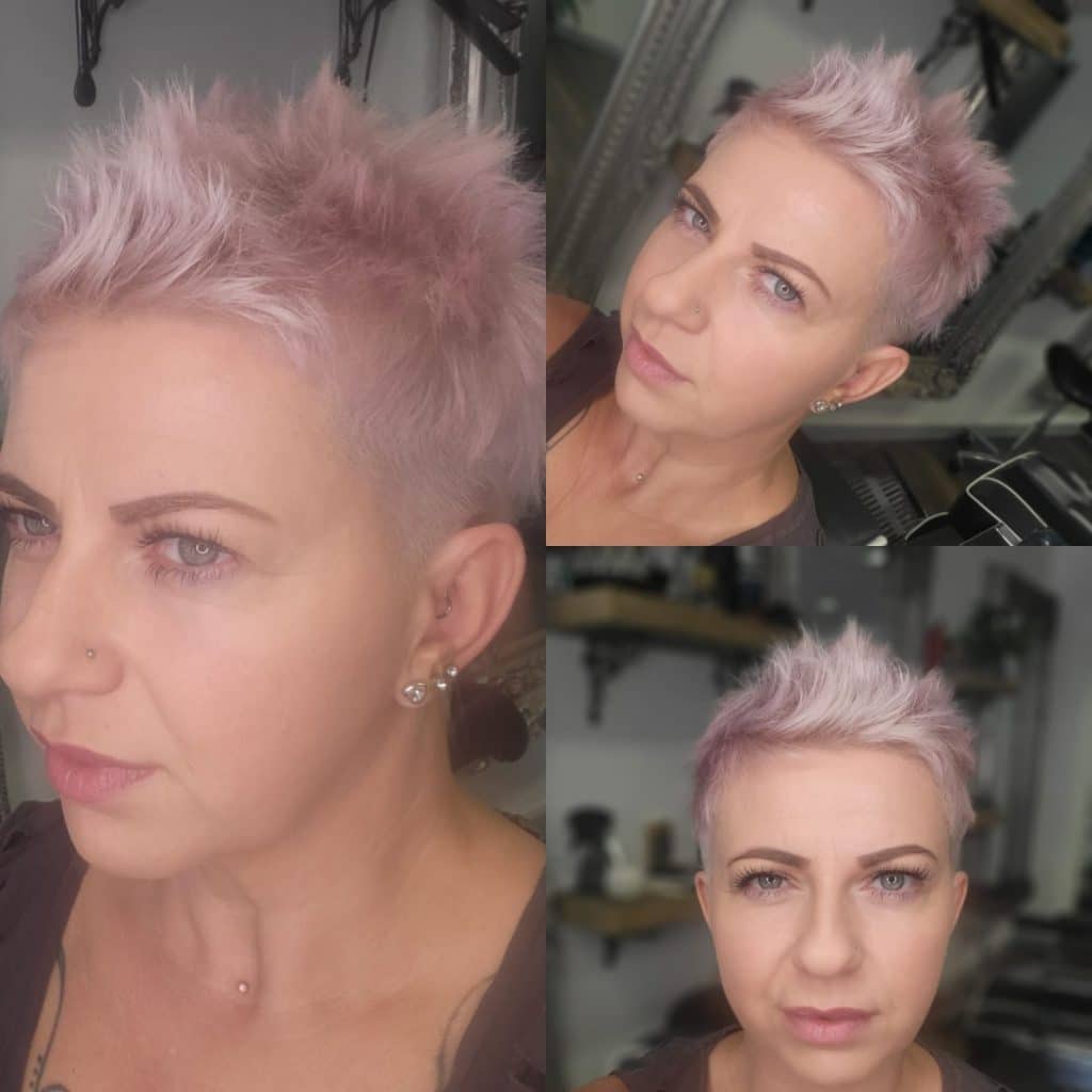 Beautiful short womens haircut, bleached blonded and toned pink.